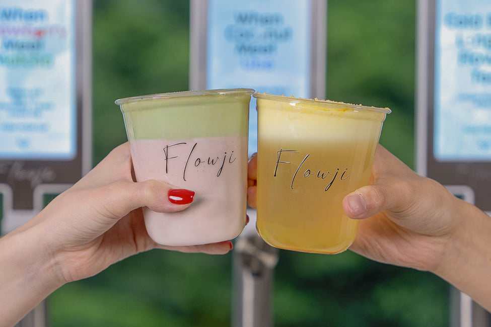 Guests clinking two Flowji signature beverages, showcasing premium drink catering and social experiences.