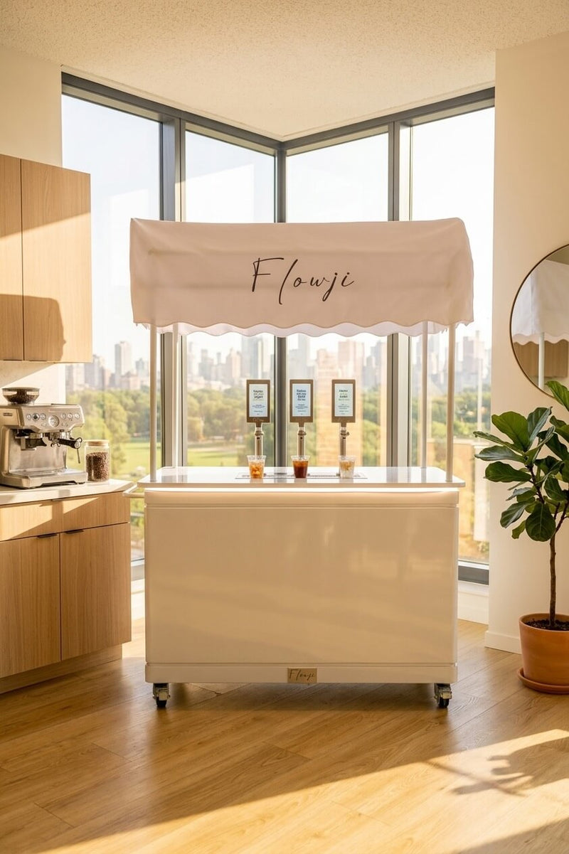 Flowji premium mobile beverage cart with branded canopy and three dispensing taps for weddings, corporate events, and large gatherings.
